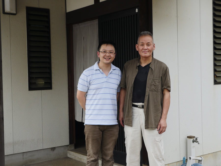 Two men standing at the entrance of Takeshi Saji's workshop, Echizen