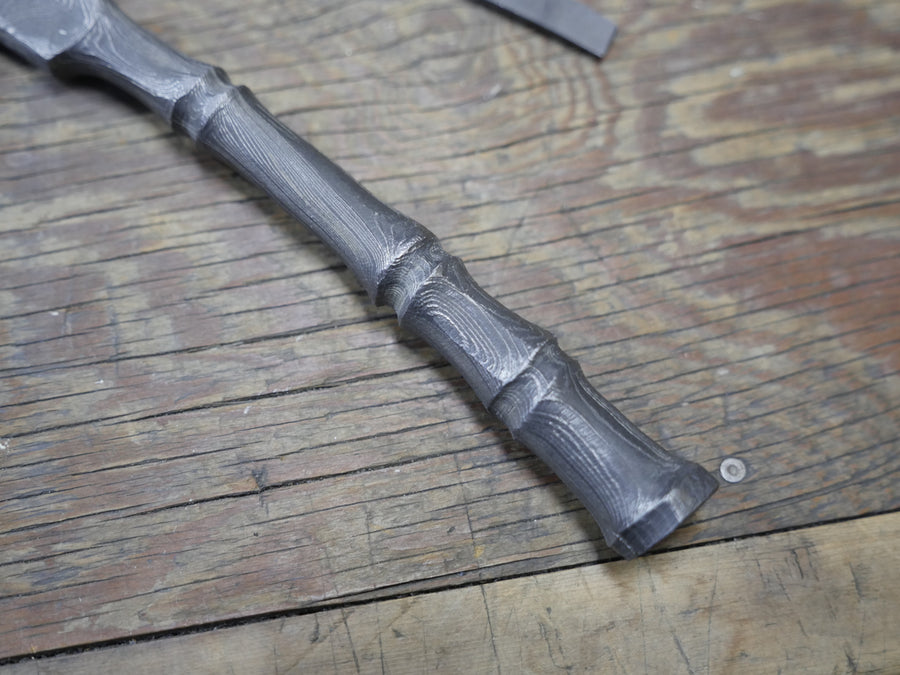 A dark tool handle resting on a workbench in Tsukasa Hinoura's Sanjo workshop, April 2016