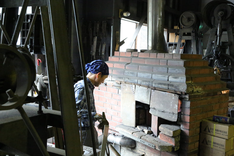 Shiro Kamo tending the brick forging furnace in his Takefu Knife Village forge, October 2015