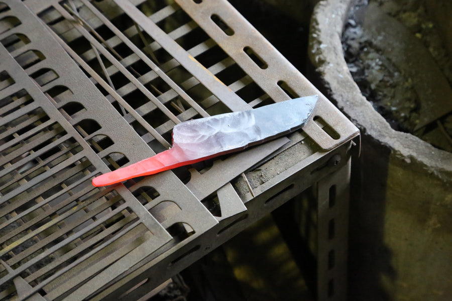 Shiro Kamo hammering a glowing steel bar on the anvil in his Takefu Knife Village forge, October 2015