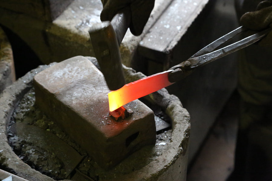A heated blade blank resting on the grate in Shiro Kamo's Takefu Knife Village forge, October 2015