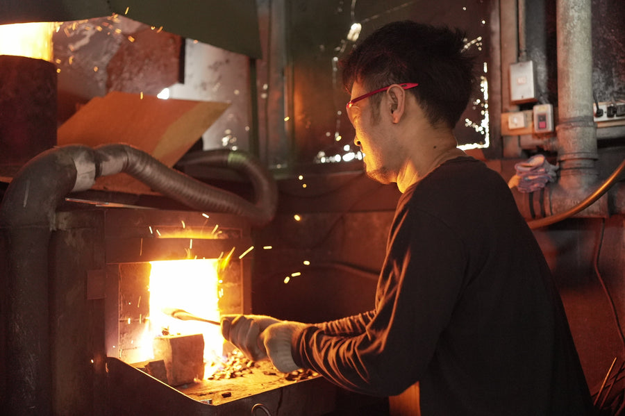 Satoshi Nakagawa tends the glowing forge in his Sakai workshop.