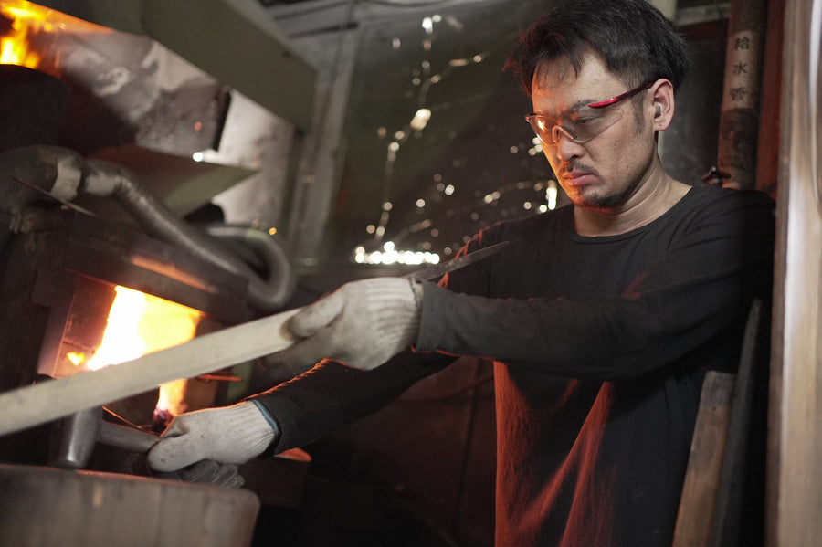 Satoshi Nakagawa handles a blade in the heat of the forge.