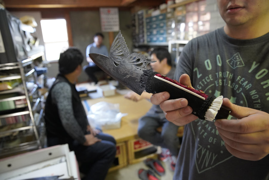 A damascus blade with a dragon motif displayed in Shigeki Tanaka's Miki workshop, 2019